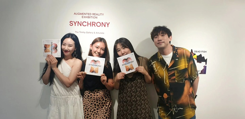 Group picture of visitors with the Synchrony exhibit card in Seoul